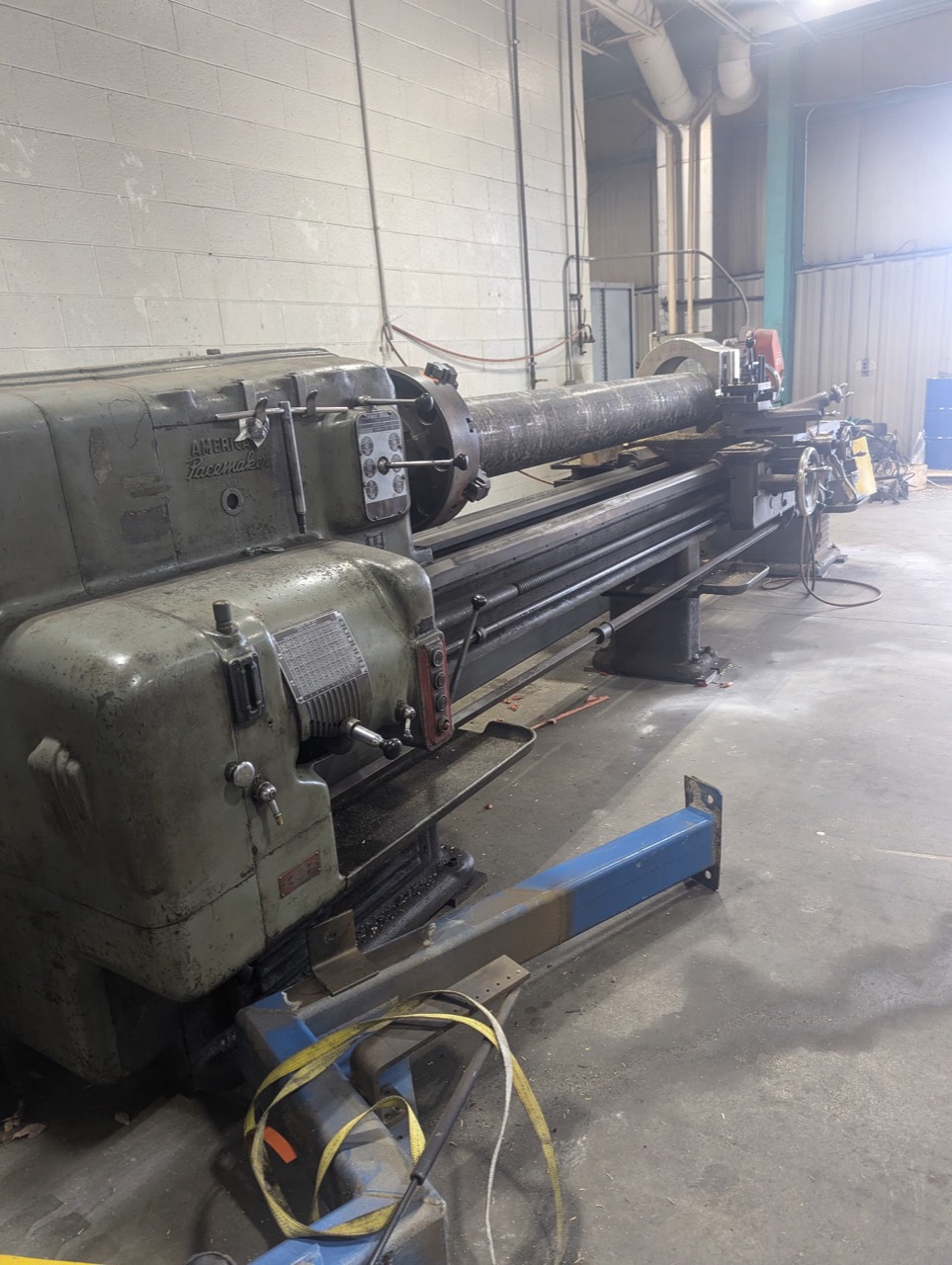 Large metalworking lathe inside a workshop